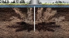 Open fissures branching through the soil around the probe.